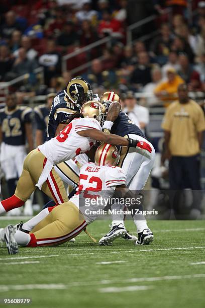 Patrick Willis and Dashon Goldson of the San Francisco 49ers tackle Steven Jackson of the St. Louis Rams during the NFL game at Edward Jones Dome on...