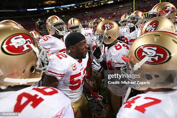 Patrick Willis and Vernon Davis of the San Francisco 49ers rally teammates in the huddle prior to the NFL game against the St. Louis Rams at Edward...