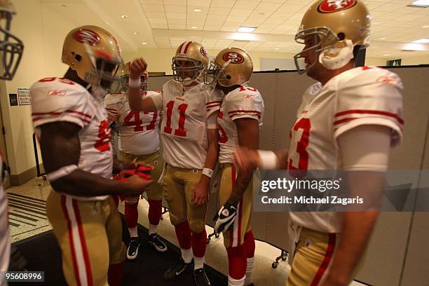 Alex Smith, Michael Crabtree and Vernon Davis of the San Francisco 49ers prepare to take the field prior to the NFL game against the St. Louis Rams...