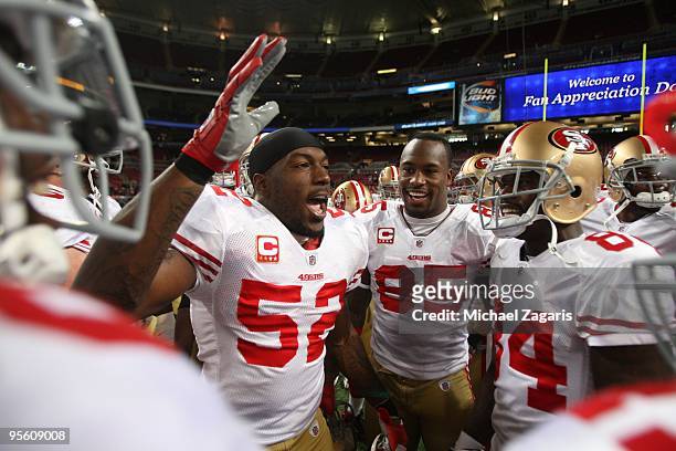 Patrick Willis and Vernon Davis of the San Francisco 49ers rally teammates in the huddle prior to the NFL game against the St. Louis Rams at Edward...