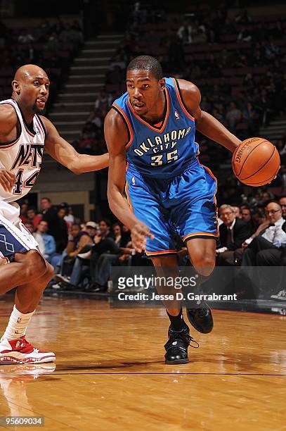 Kevin Durant of the Oklahoma City Thunder drives against Trenton Hassell of the New Jersey Nets during the game on December 28, 2009 at the Izod...