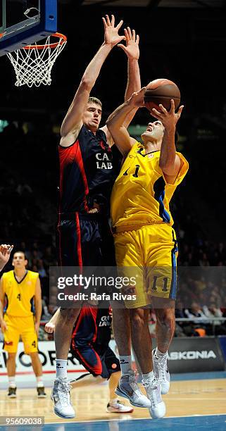 Dimitrios Mavroeidis, #11 of Maroussi BC competes with Stanko Barac, #42 of Caja Laboral during the Euroleague Basketball Regular Season 2009-2010...