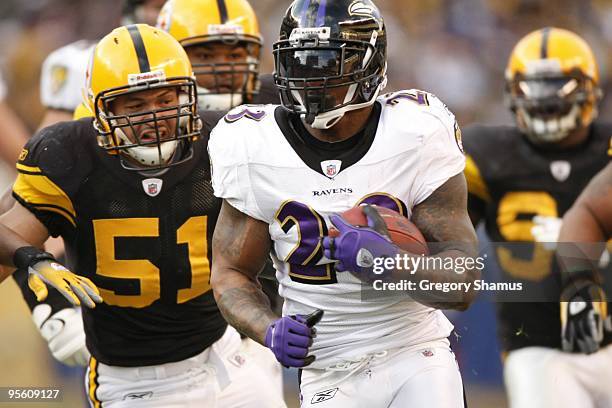 Willis McGahee of the Baltimore Ravens carries the ball against James Farrior of the Pittsburgh Steelers on December 27, 2009 at Heinz Field in...