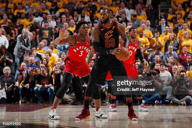 LeBron James of the Cleveland Cavaliers handles the ball against OG Anunoby of the Toronto Raptors during Game Four of the Eastern Conference...