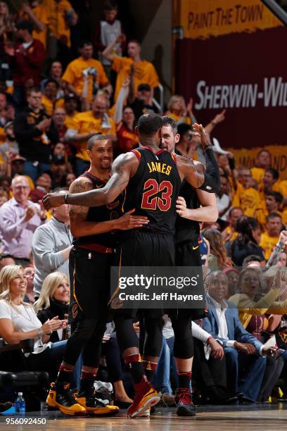 Lebron James, George Hill and Kevin Love hug during the game against the Toronto Raptors in Game Four of the Eastern Conference Semifinals of the...