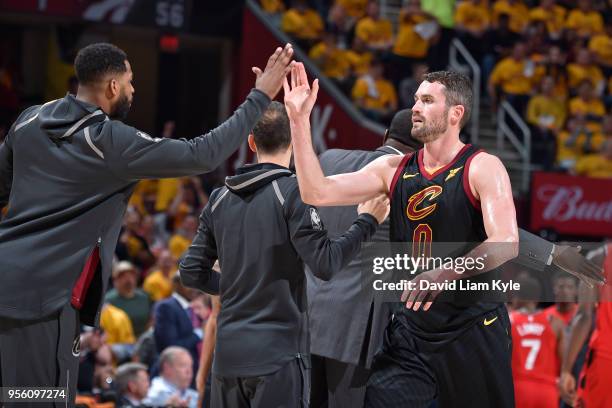 Kevin Love of the Cleveland Cavaliers high-fives Tristan Thompson of the Cleveland Cavaliers during the game against the Toronto Raptors in Game Four...