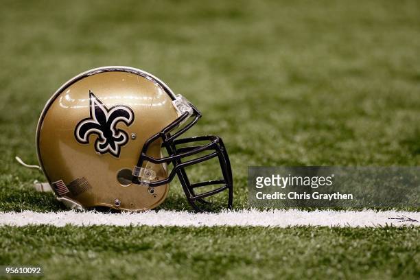 Helmet of the New Orleans Saints sits on the ground before the game against the Dallas Cowboys at the Louisiana Superdome on December 19, 2009 in New...