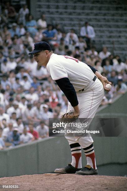 Pitcher Dick Radatz of the Boston Red Sox gets the sign for the next pitch while standing on the mound during a game circa 1964 at Fenway Park in...