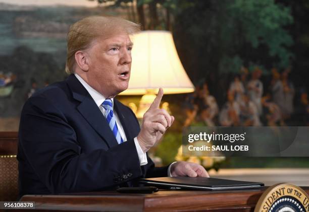 President Donald Trump speaks to the press after signing a document reinstating sanctions against Iran after announcing the US withdrawal from the...