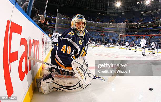 Patrick Lalime of the Buffalo Sabres stops the puck while finding the camera in warmups before their game against the Tampa Bay Lightning on January...