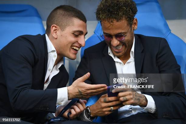 Paris Saint-Germain's Italian midfielder Marco Verratti shares a laugh with Paris Saint-Germain's Brazilian forward Neymar Jr ahead of the French Cup...
