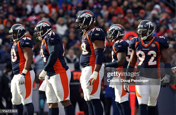 Kenny Peterson, Ronald Fields, Ryan McBean and Elvis Dumervil of the Denver Broncos defense prepare for action against the Kansas City Chiefs during...