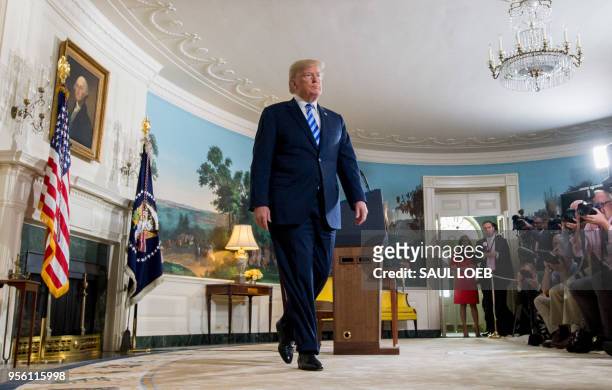 President Donald Trump leaves after announcing his decision about the nuclear deal with Iran during a speech from the Diplomatic Reception Room at...