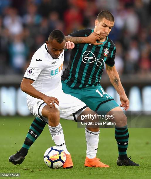 Jordan Ayew of Swansea City holds off Oriol Romeu of Southampton during the Premier League match between Swansea City and Southampton at Liberty...