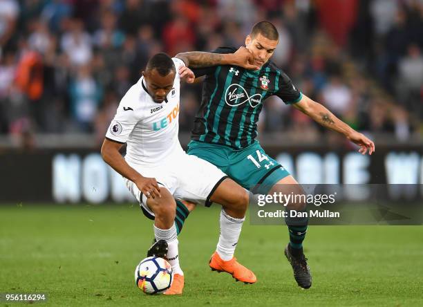 Jordan Ayew of Swansea City holds off Oriol Romeu of Southampton during the Premier League match between Swansea City and Southampton at Liberty...