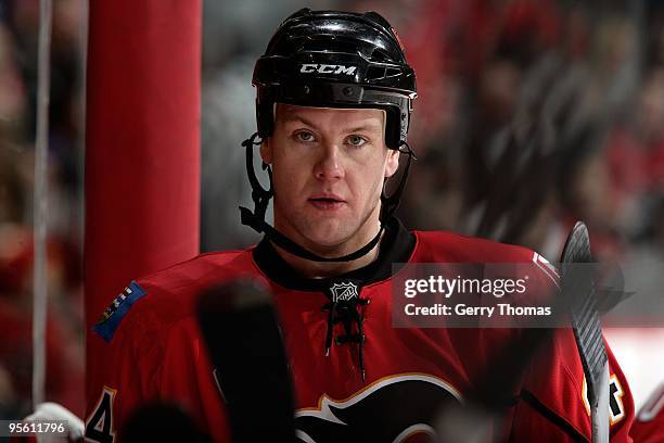 Aaron Johnson of the Calgary Flames stands by the bench during a stoppage in play against the Los Angeles Kings on December 30, 2009 at Pengrowth...