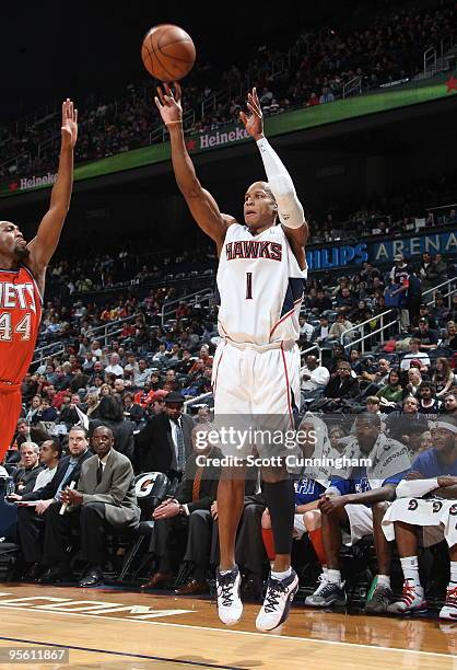 Maurice Evans of the Atlanta Hawks puts up a shot against Trenton Hassell of the New Jersey Nets on January 6, 2010 at Philips Arena in Atlanta,...