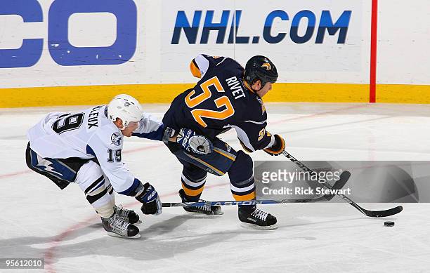 Craig Rivet of the Buffalo Sabres cuts toward the net as Stephane Veilleux of the Tampa Bay Lightning defends at HSBC Arena on January 6, 2010 in...