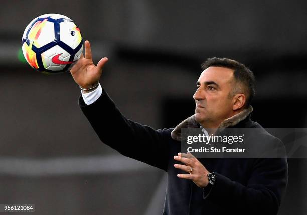 Carlos Carvalhal, Manager of Swansea City catches the ball during the Premier League match between Swansea City and Southampton at Liberty Stadium on...