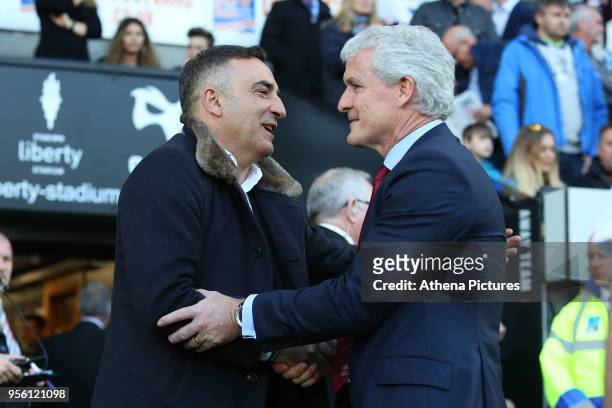 Swansea City manager Carlos Carvalhal and Southampton manager Mark Hughes shake hands prior to kick off of the Premier League match between Swansea...