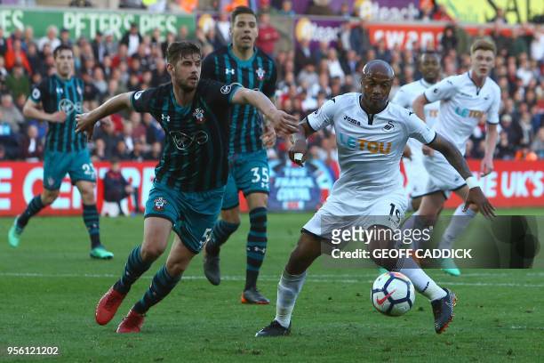 Southampton's English defender Jack Stephens vie with Swansea's Ghanaian strriker Andre Ayew during the English Premier League football match between...