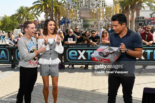 Mario Lopez gives a gift of Diet Coke and M&M's to Adam Rippon and Jenna Johnson visit "Extra" at Universal Studios Hollywood on May 8, 2018 in...