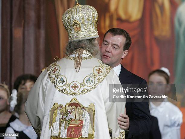 Russian President Dmitry Medvedev and Russian Orthodox Church Patriarch Kirill greet each other during an Orthodox Christmas service at Cathedral of...