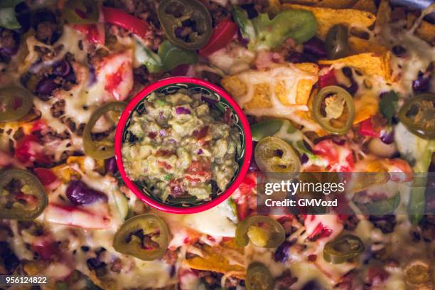 nachos tortilla chips with salsa, minced meat and jalapenos - corn salsa stock pictures, royalty-free photos & images