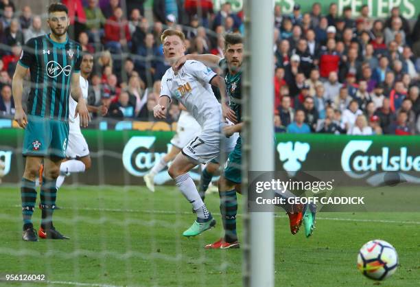 Swansea City's English midfielder Sam Clucas watches his shot go wide during the English Premier League football match between Swansea City and...