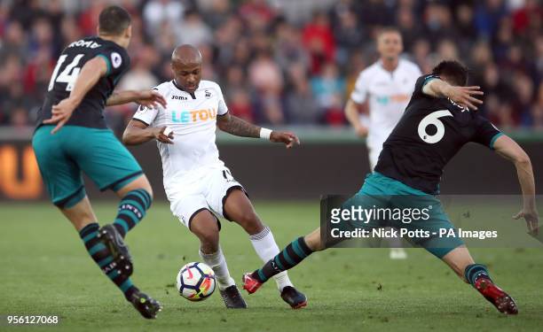 Swansea City's Andre Ayew battles for the ball with Southampton's Oriol Romeu and Wesley Hoedt during the Premier League match at the Liberty...