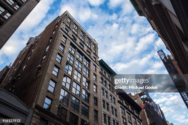 modern new york city buildings against a bright blue fall sky - buildings looking up stock pictures, royalty-free photos & images