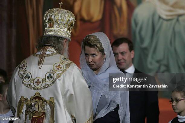 Russian Orthodox Church Patriarch Kirill greets Svetlana Medvedeva and her husband Russian President Dmitry Medvedev during an Orthodox Christmas...