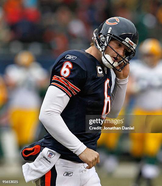 Jay Cutler of the Chicago Bears runs off the field after getting sacked during a game against the Green Bay Packers at Soldier Field on December 13,...