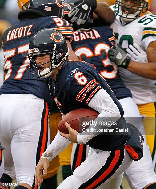 Jay Cutler of the Chicago Bears tries to avoid a Green Bay Packer rush at Soldier Field on December 13, 2009 in Chicago, Illinois. The Packers...