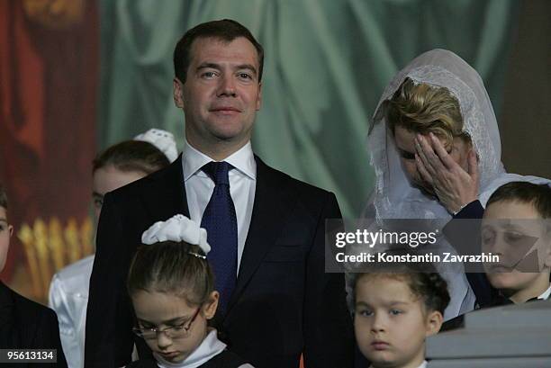Russian President Dmitry Medvedev and his wife Svetlana Medvedeva, surrounded by children, attend an Orthodox Christmas service at Cathedral of...