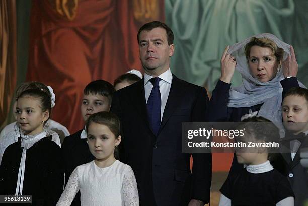 Russian President Dmitry Medvedev and his wife Svetlana Medvedeva, surrounded by children, attend an Orthodox Christmas service at Cathedral of...