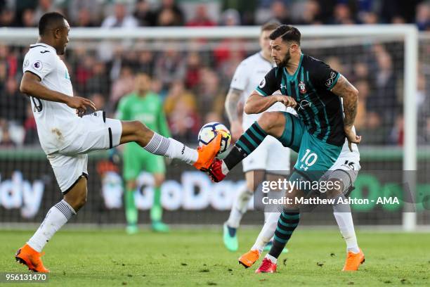 Jordan Ayew of Swansea City and Charlie Austin of Southampton during the Premier League match between Swansea City and Southampton at Liberty Stadium...