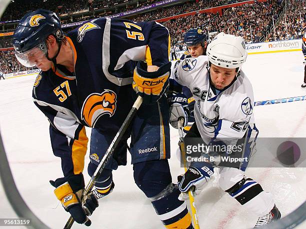 Tyler Myers of the Buffalo Sabres battles for the puck along the boards with Martin St Louis of the Tampa Bay Lightning on January 6, 2010 at HSBC...