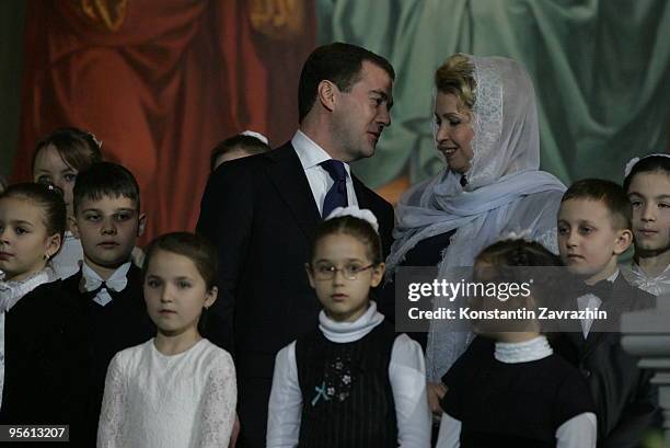 Russian President Dmitry Medvedev and his wife Svetlana Medvedeva, surrounded by children, attend an Orthodox Christmas service at Cathedral of...