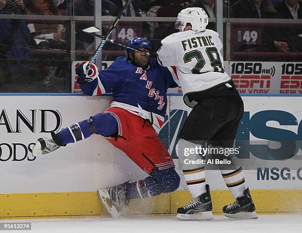 Donald Brashear of the New York Rangers is checked by Mark Fistric of the Dallas Stars during their game on January 6, 2010 at Madison Square Garden...