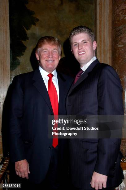 Donald Trump poses with his son Eric at the Mar-a-Lago club on Thanksgiving Day, in Palm Beach, Florida, November 23, 2006.