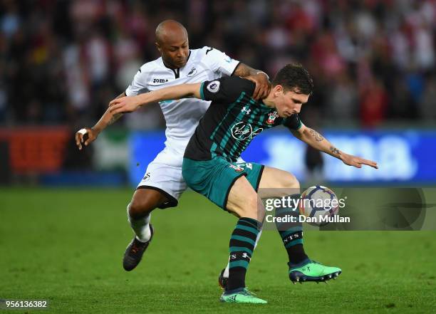 Pierre-Emile Hojbjerg of Southampton holds off Andre Ayew of Swansea City during the Premier League match between Swansea City and Southampton at...