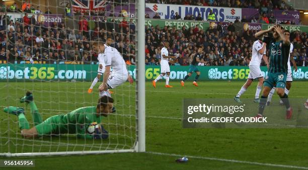 Southampton's English striker Charlie Austin reacts after failing to score during the English Premier League football match between Swansea City and...