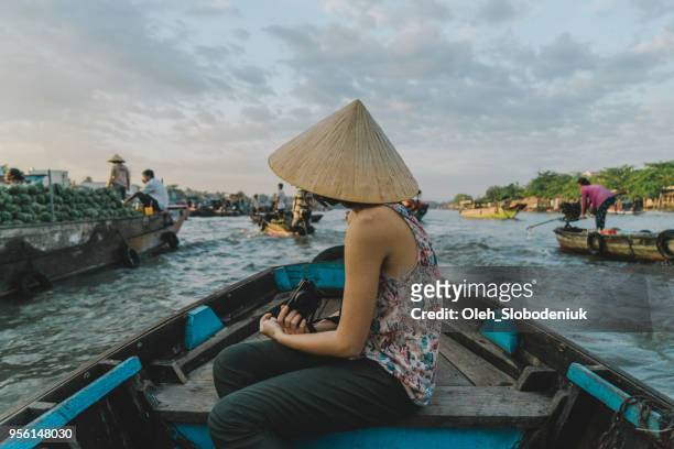 woman riding on boat through mekong delta and floating market - hot vietnamese women stock pictures, royalty-free photos & images
