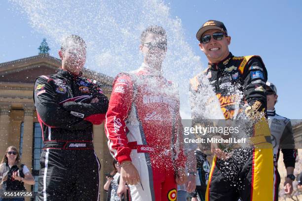 Daniel Hemric shoots off champagne on top of the Art Museum steps during the 3rd Annual NASCAR Xfinity Philadelphia Takeover on May 8, 2018 in...
