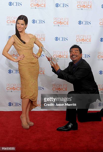 Actress Sandra Bullock and comedian George Lopez pose with Bullock's Favorite Movie Actress award in the press room during the People's Choice Awards...