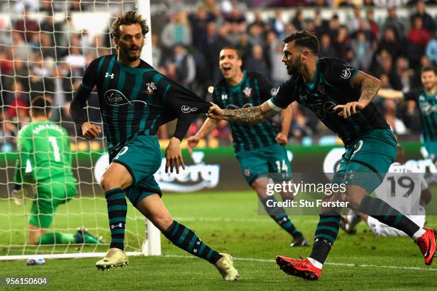 Manolo Gabbiadini of Southampton celebrates with Charlie Austin after he scores his sides first goal during the Premier League match between Swansea...