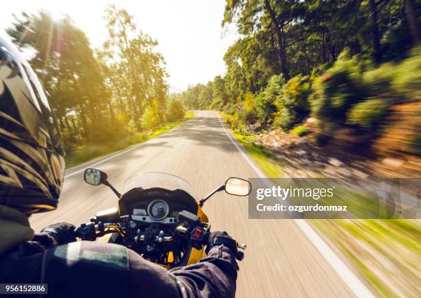 motorbike ride on a country road - motorbike rider stock pictures, royalty-free photos & images