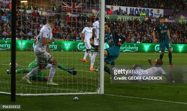 Southampton's Italian striker Manolo Gabbiadini scores his team's first goal during the English Premier League football match between Swansea City...