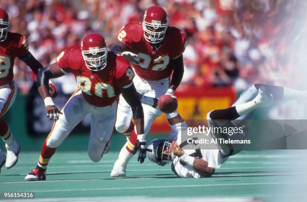 Kansas City Chiefs Neil Smith in action, forcing fumble vs Los Angeles Raiders QB Vince Evans at Arrowhead Stadium. Kansas City, MO 10/3/1993 CREDIT:...